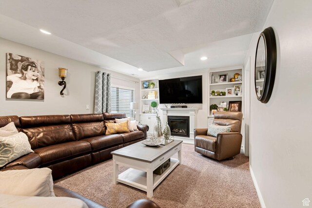 7989 S Bury Rd, West Jordan, UT 84081 - carpeted living room with a glass covered fireplace, baseboards, a textured ceiling, and recessed lighting