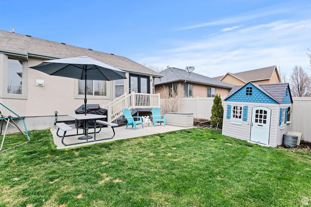 7989 S Bury Rd, West Jordan, UT 84081 - back of property with central air condition unit, fence, a storage unit, an outbuilding, and a patio area