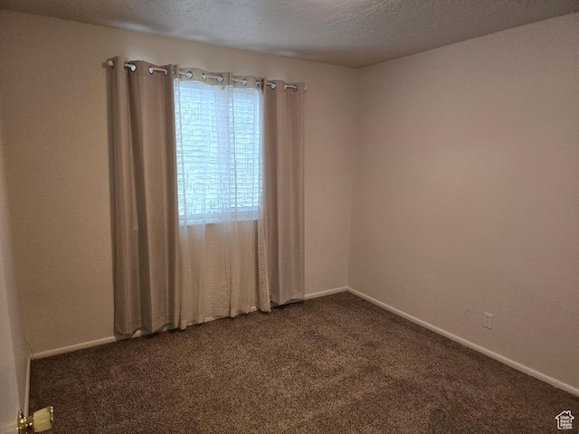 1039 E Quail Vista Ln Unit A, Millcreek, UT 84117 - spare room featuring baseboards, dark colored carpet, and a textured ceiling
