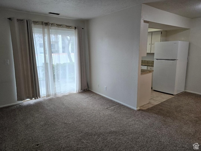 1039 E Quail Vista Ln Unit A, Millcreek, UT 84117 - spare room with visible vents, baseboards, light colored carpet, and a textured ceiling