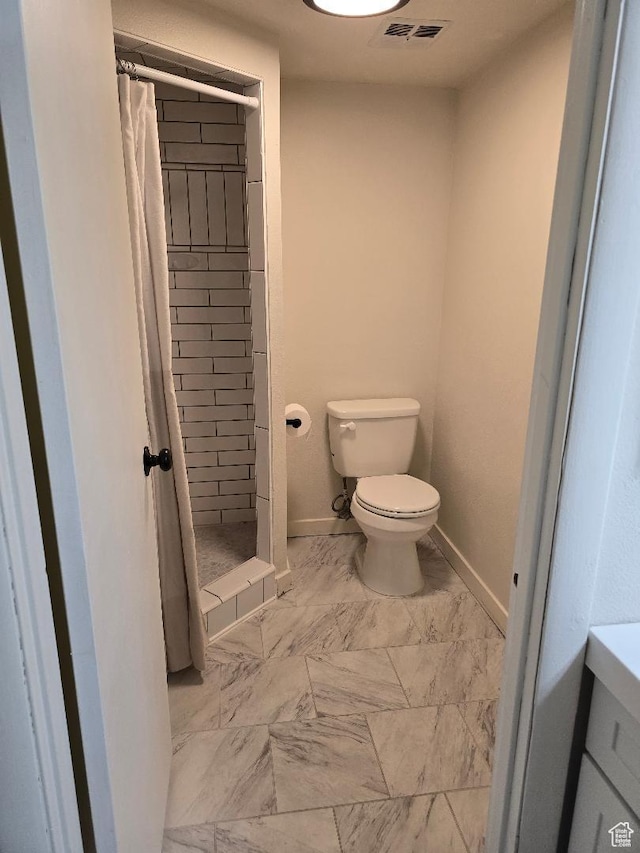 1039 E Quail Vista Ln Unit A, Millcreek, UT 84117 - full bath with toilet, a shower stall, marble finish floor, baseboards, and visible vents