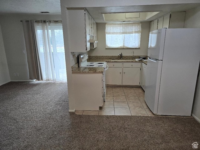 1039 E Quail Vista Ln Unit A, Millcreek, UT 84117 - kitchen featuring light colored carpet, white appliances, under cabinet range hood, a sink, and white cabinets