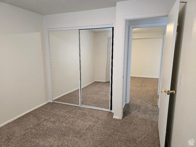 1039 E Quail Vista Ln Unit A, Millcreek, UT 84117 - unfurnished bedroom with carpet flooring, baseboards, and a closet