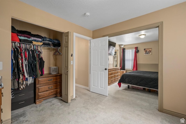bedroom featuring light carpet and a closet