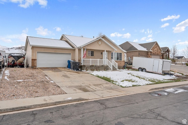 ranch-style home with an attached garage, covered porch, and driveway