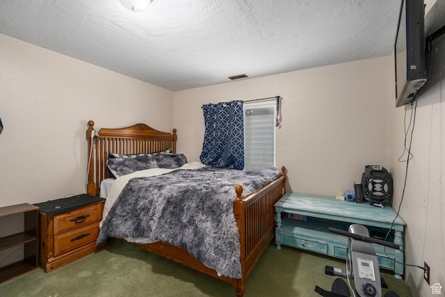 carpeted bedroom with visible vents and a textured ceiling