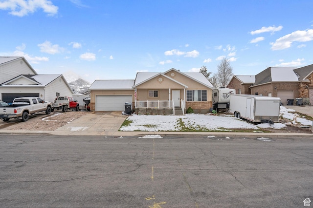 view of front of house with a garage, a residential view, and concrete driveway