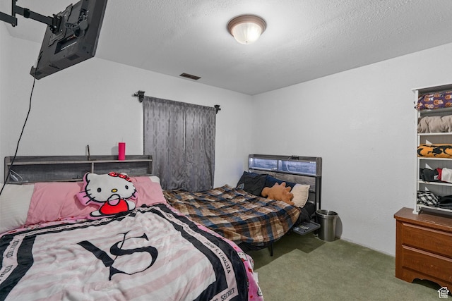 carpeted bedroom with a textured ceiling and visible vents