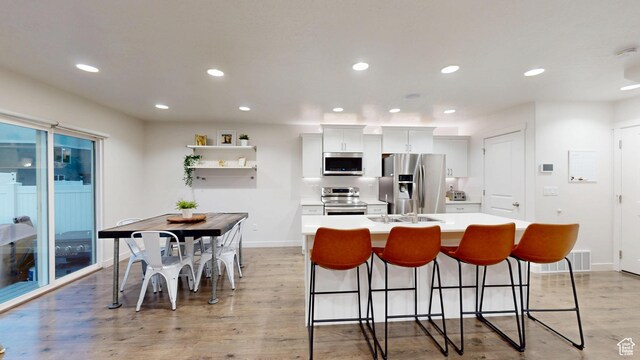14952 S Messi St, Herriman, UT 84096 - kitchen featuring light countertops, a center island with sink, appliances with stainless steel finishes, and recessed lighting