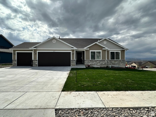 craftsman house featuring an attached garage, driveway, stone siding, and a front yard