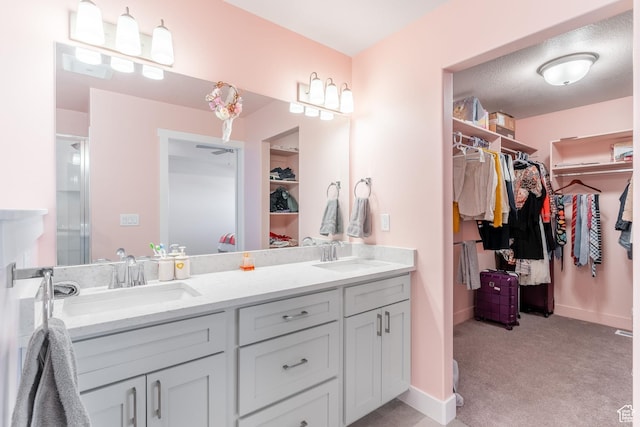 437 N 800 E, Hyde Park, UT 84318 - full bathroom featuring a spacious closet, baseboards, a sink, and double vanity