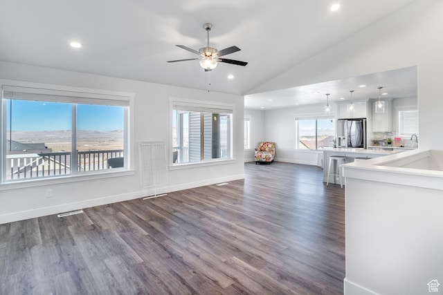 437 N 800 E, Hyde Park, UT 84318 - unfurnished living room with dark wood-type flooring, vaulted ceiling, ceiling fan, and recessed lighting