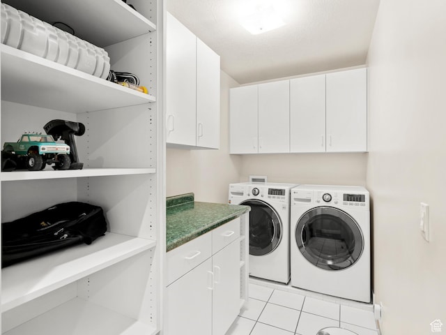 clothes washing area featuring cabinet space, separate washer and dryer, and light tile patterned floors