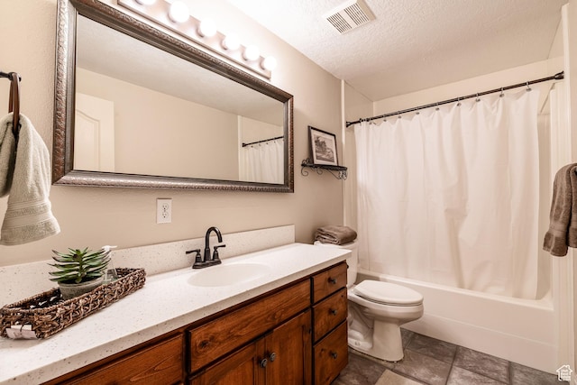 981 Eastridge Dr, Logan, UT 84321 - full bath featuring visible vents, toilet, vanity, stone finish flooring, and shower / bath combo with shower curtain