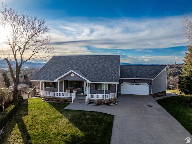 981 Eastridge Dr, Logan, UT 84321 - view of front of property featuring an attached garage, driveway, a front lawn, and covered porch