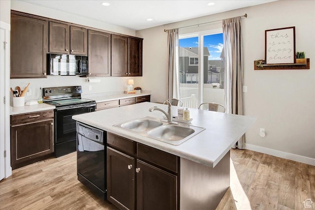 5197 W Copeland Dr S, Herriman, UT 84096 - kitchen with light countertops, a sink, light wood-style flooring, baseboards, and black appliances