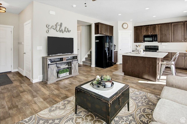 5197 W Copeland Dr S, Herriman, UT 84096 - living room featuring baseboards, recessed lighting, wood finished floors, and stairway