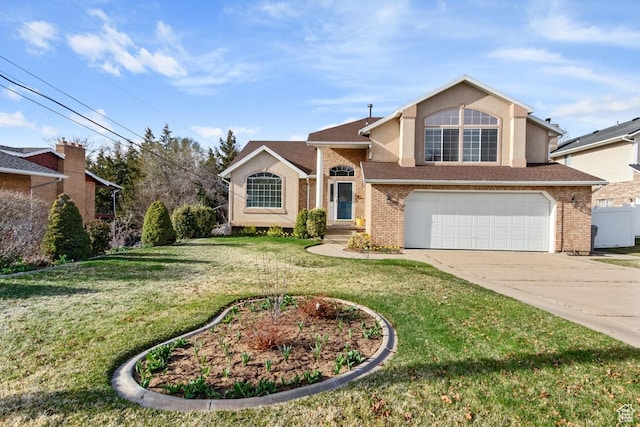 traditional-style home with fence, an attached garage, a front yard, brick siding, and driveway
