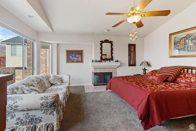 846 E Holroyd S, South Ogden, UT 84403 - bedroom with vaulted ceiling, a tile fireplace, a ceiling fan, baseboards, and carpet