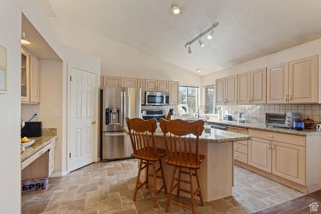 846 E Holroyd S, South Ogden, UT 84403 - kitchen with stone finish floor, a toaster, light brown cabinetry, and appliances with stainless steel finishes