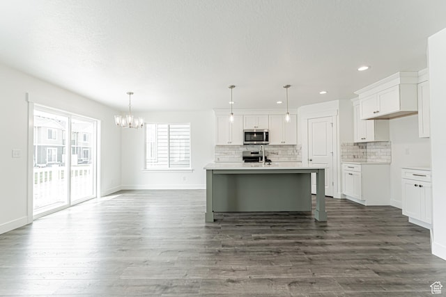 3671 W 950 N Unit 218, Lehi, UT 84043 - kitchen with appliances with stainless steel finishes, a chandelier, white cabinets, tasteful backsplash, and recessed lighting