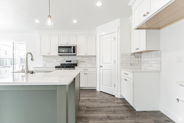 3671 W 950 N Unit 218, Lehi, UT 84043 - kitchen with appliances with stainless steel finishes, light countertops, dark wood finished floors, recessed lighting, and backsplash