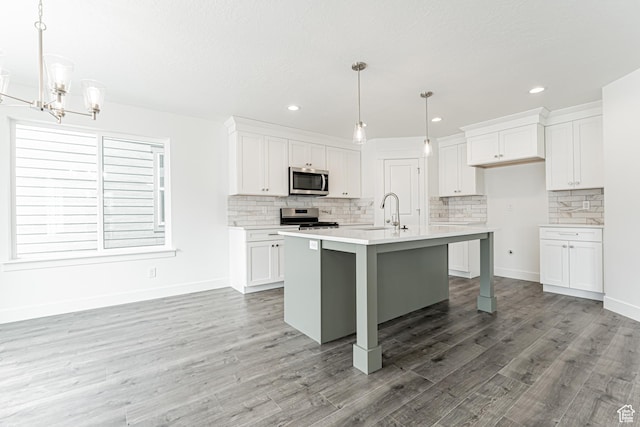 3671 W 950 N Unit 218, Lehi, UT 84043 - kitchen with stainless steel appliances, decorative backsplash, white cabinetry, light countertops, and light wood-type flooring