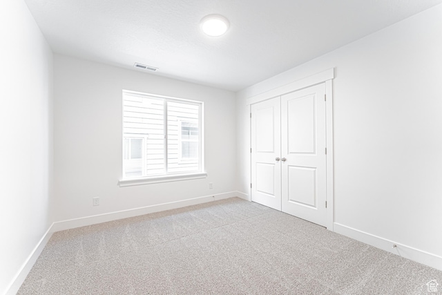 3671 W 950 N Unit 218, Lehi, UT 84043 - unfurnished bedroom featuring light colored carpet and a closet