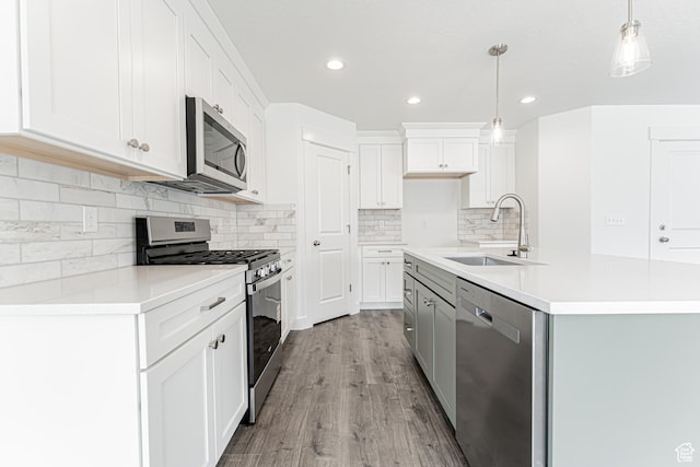 3671 W 950 N Unit 218, Lehi, UT 84043 - kitchen featuring appliances with stainless steel finishes, decorative light fixtures, light wood-type flooring, white cabinetry, and light countertops
