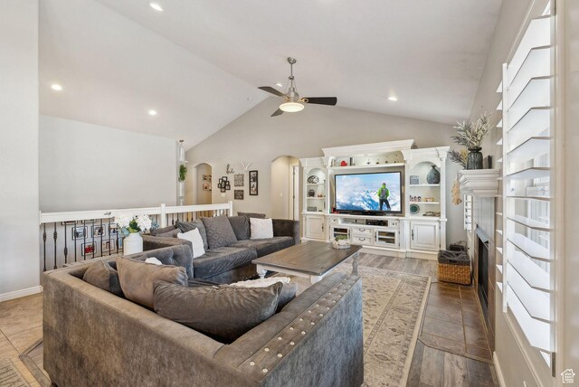 living room featuring high vaulted ceiling, arched walkways, a ceiling fan, and recessed lighting