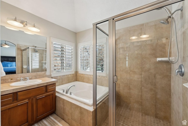 bathroom featuring vanity, a bath, connected bathroom, and a stall shower