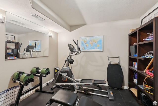 workout room with visible vents, baseboards, and a textured ceiling