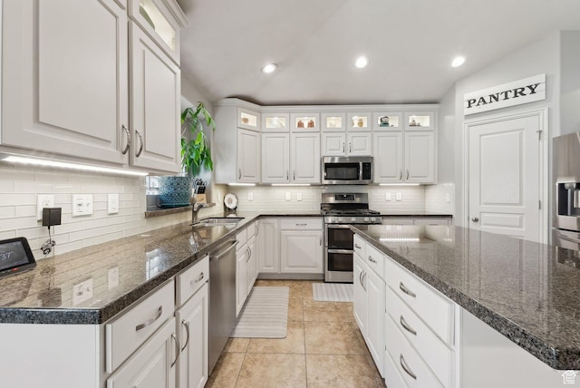 kitchen with recessed lighting, light tile patterned floors, backsplash, white cabinets, and appliances with stainless steel finishes