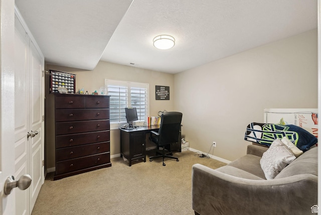 office area featuring light colored carpet and baseboards