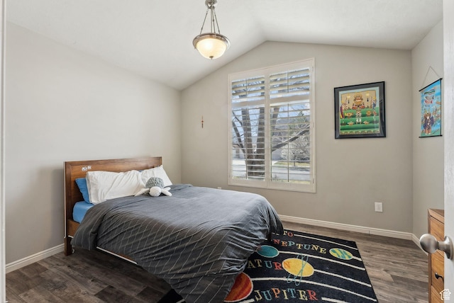 bedroom featuring wood finished floors, baseboards, and vaulted ceiling