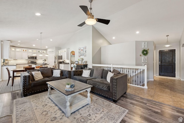 living area featuring wood finished floors, ceiling fan, and recessed lighting