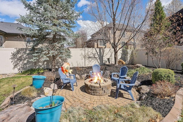 view of patio / terrace with a fenced backyard and an outdoor fire pit