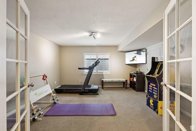 exercise area featuring carpet, french doors, a textured ceiling, and baseboards