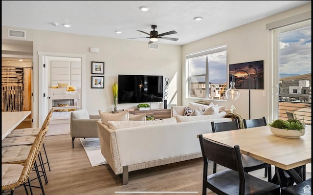 living room with visible vents, recessed lighting, a ceiling fan, and wood finished floors