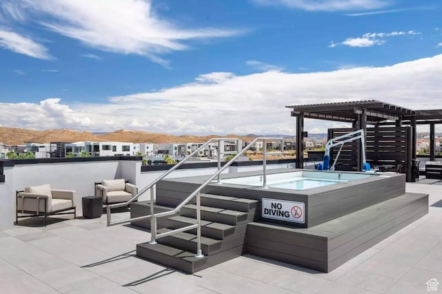 875 W Akoya Pearl St Unit 303, St George, UT 84790 - view of patio / terrace with a jacuzzi, a pergola, and a mountain view