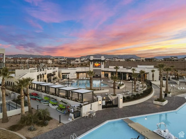 875 W Akoya Pearl St Unit 303, St George, UT 84790 - pool at dusk with a community pool and a mountain view