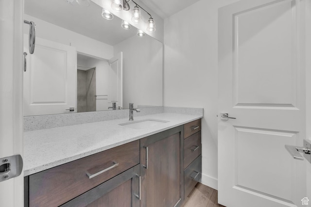 864 N Gleneagles Ct W, Tooele, UT 84074 - bathroom with baseboards, wood finished floors, and vanity