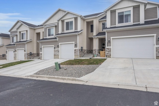 864 N Gleneagles Ct W, Tooele, UT 84074 - view of front facade with stone siding, board and batten siding, driveway, and an attached garage