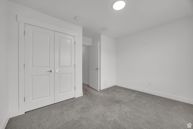 864 N Gleneagles Ct W, Tooele, UT 84074 - unfurnished bedroom with baseboards, a closet, and carpet flooring