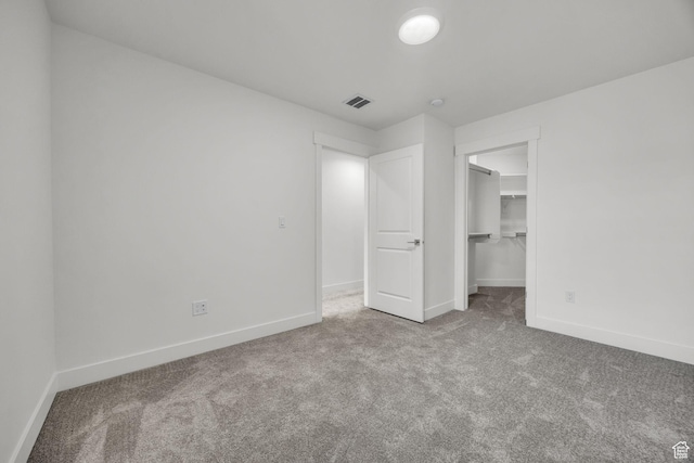864 N Gleneagles Ct W, Tooele, UT 84074 - unfurnished bedroom featuring a spacious closet, carpet, baseboards, visible vents, and a closet