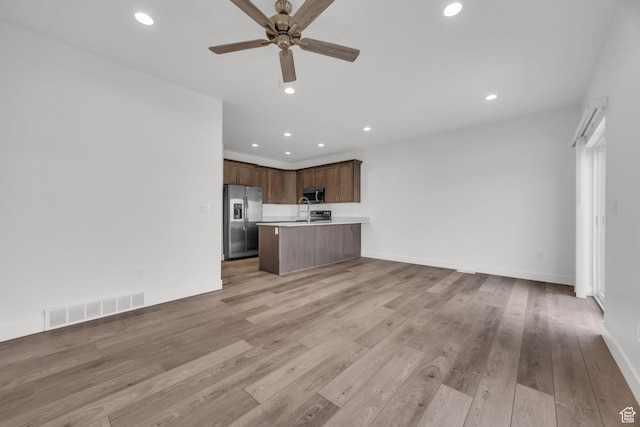 864 N Gleneagles Ct W, Tooele, UT 84074 - unfurnished living room with a ceiling fan, recessed lighting, light wood-style flooring, and visible vents