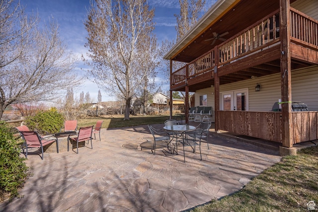 98 E Mt Peale Dr, Moab, UT 84532 - view of patio / terrace featuring french doors, a deck, outdoor dining area, ceiling fan, and a fire pit