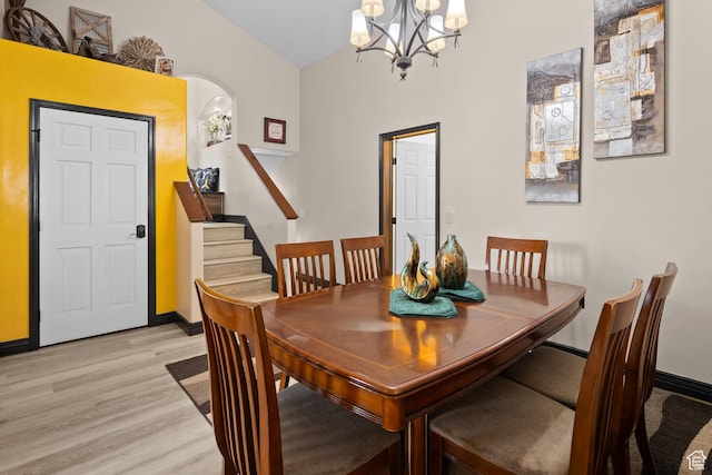 98 E Mt Peale Dr, Moab, UT 84532 - dining room featuring baseboards, light wood-type flooring, stairway, and a notable chandelier