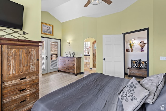 98 E Mt Peale Dr, Moab, UT 84532 - bedroom featuring high vaulted ceiling, access to exterior, wood finished floors, and arched walkways