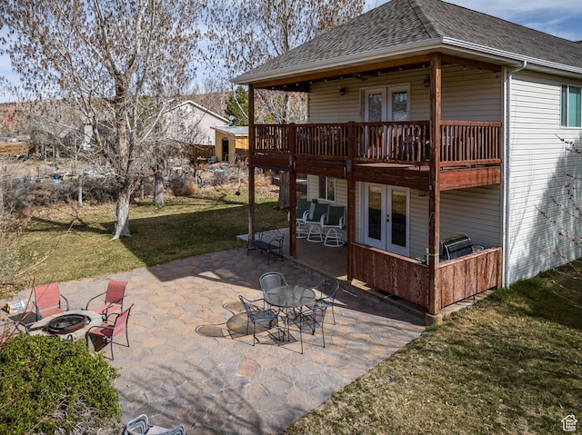 98 E Mt Peale Dr, Moab, UT 84532 - back of property with roof with shingles, a patio, french doors, an outdoor fire pit, and a lawn